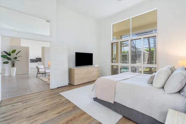 a bedroom with a bed and a flat screen tv
