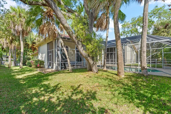 front view of a house with a big yard and large trees