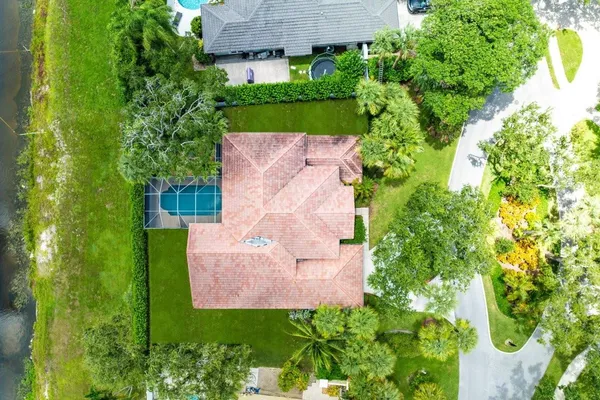 an aerial view of a house with a yard and garden