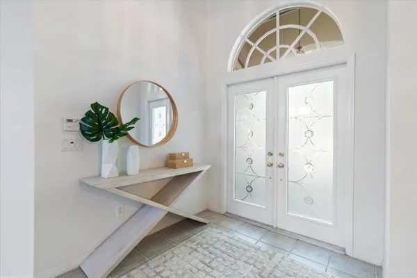 a front view of a house with wooden floor and a potted plant