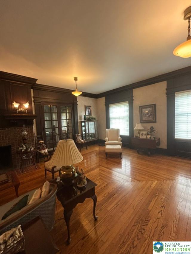 1170 Mosser Road Breinigsville, PA 18031 - Photo 15 of 19 Rich hardwood flooring and intricate dark wood trim define this elegant living space.