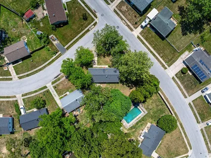 an aerial view of house with a yard