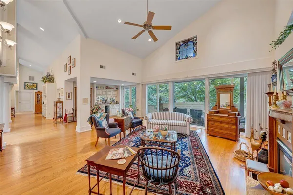 a view of a livingroom with a fireplace wooden floor and window