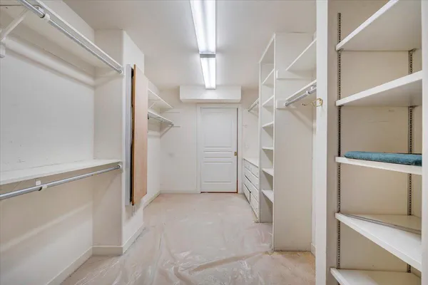 a view of outdoor sitting area with chairs and wooden fence