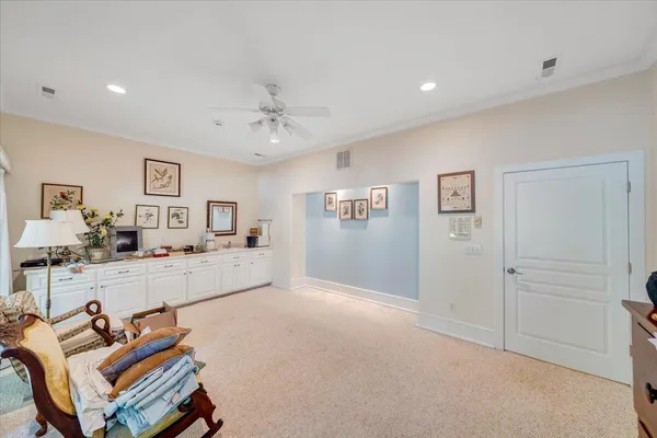 a view of a house with a yard and potted plants