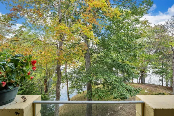 an aerial view of a house with a yard and lake view