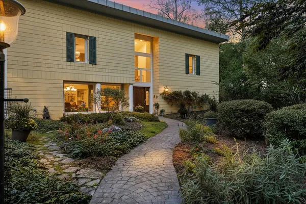 a living room with hard wood flooring and a book shelf