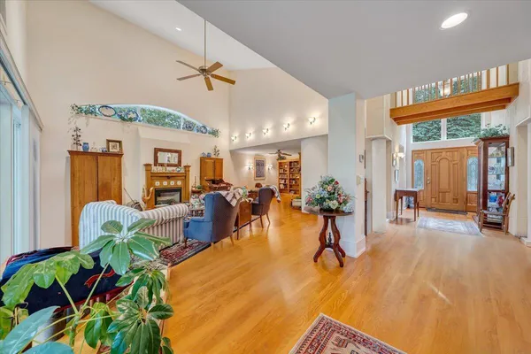 a living room with furniture a rug and a floor to ceiling window