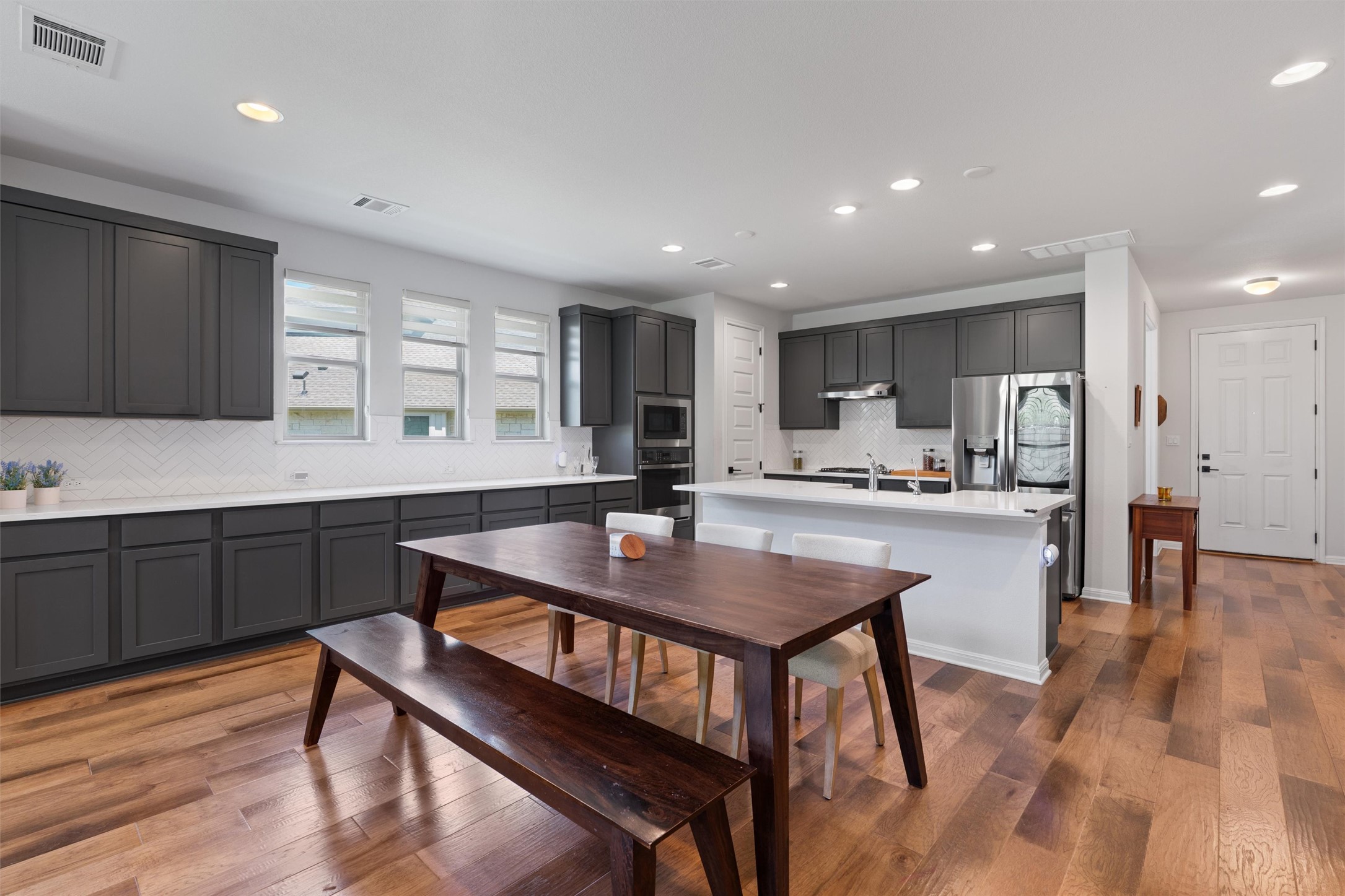 1908 Cabrera Drive Leander, TX 78641 - Photo 13 of 37 a kitchen with a table chairs a sink and cabinets