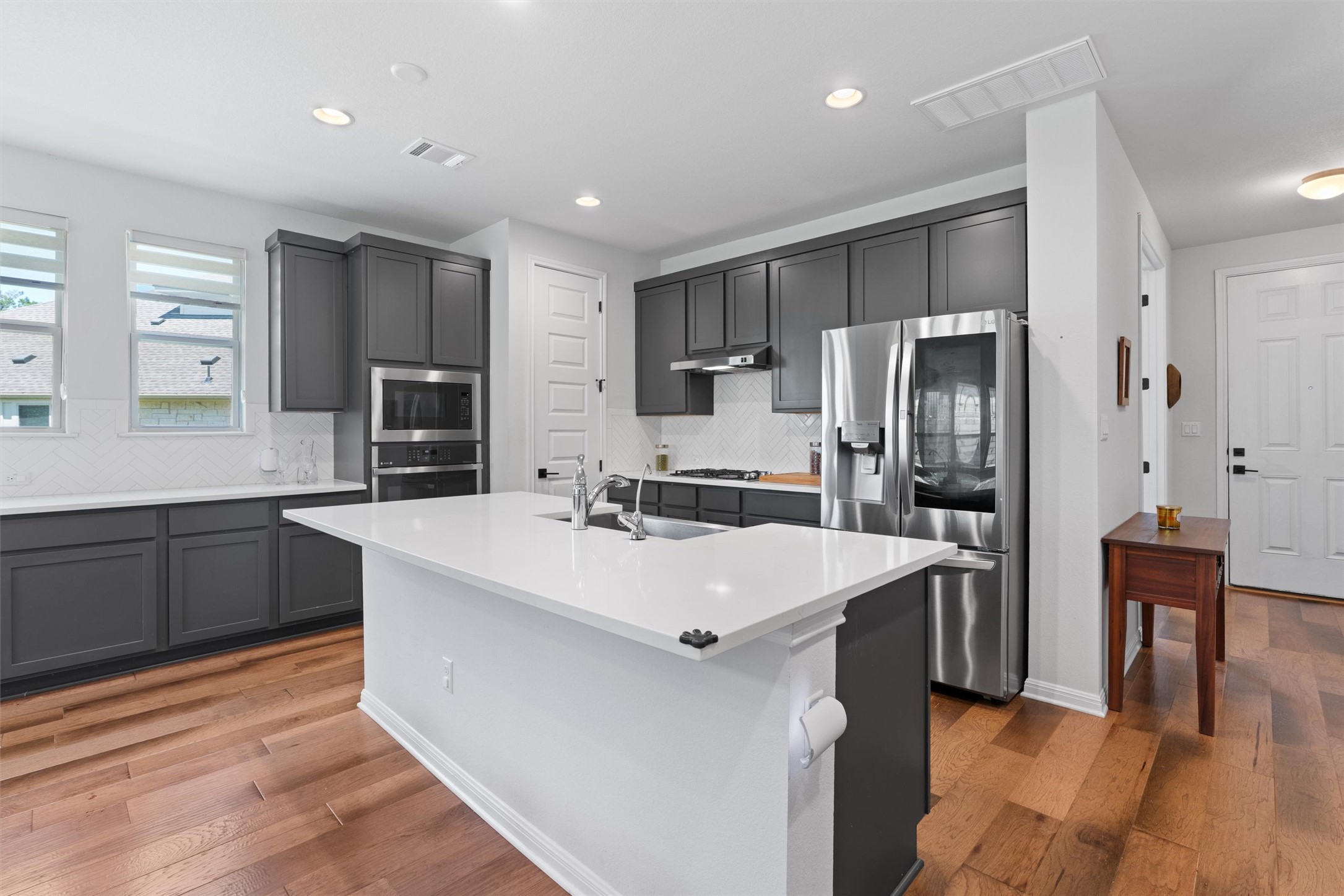 1908 Cabrera Drive Leander, TX 78641 - Photo 9 of 37 a large kitchen with stainless steel appliances a refrigerator and a stove top oven