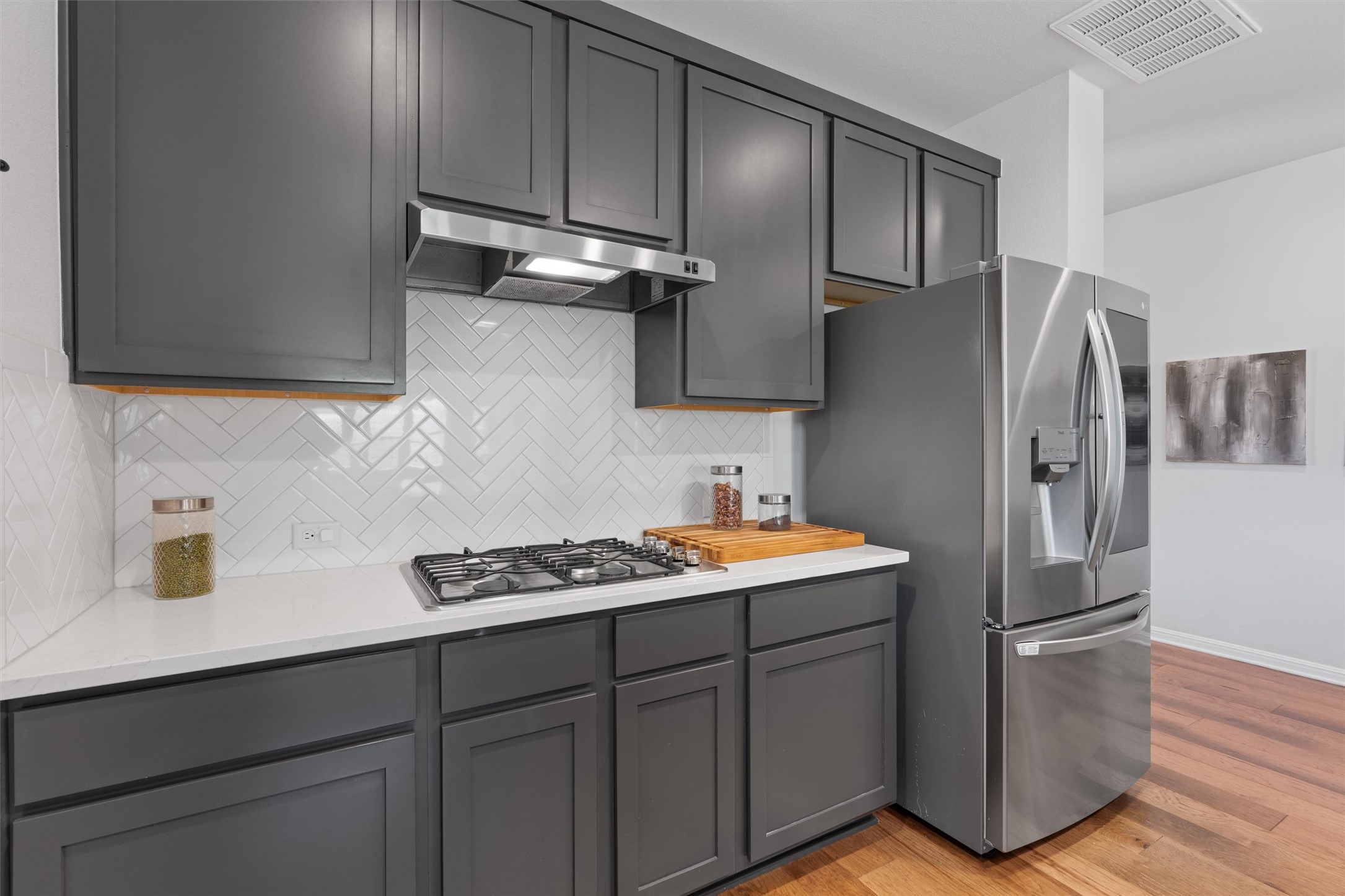 1908 Cabrera Drive Leander, TX 78641 - Photo 10 of 37 a kitchen with stainless steel appliances a refrigerator a sink and wooden cabinets