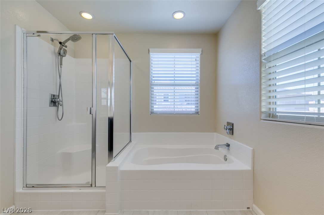 2549 Sable Ridge Street Henderson, NV 89044 - Photo 45 of 48 Relax in the serene bath, featuring a separate glass-enclosed shower and natural light.