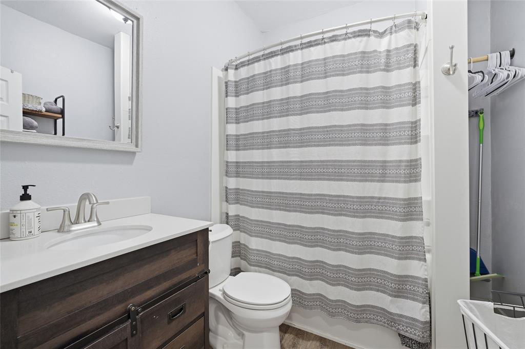 2320 Mistletoe Street Waco, TX 76706 - Photo 15 of 23 a bathroom with a sink a toilet a shower and a mirror