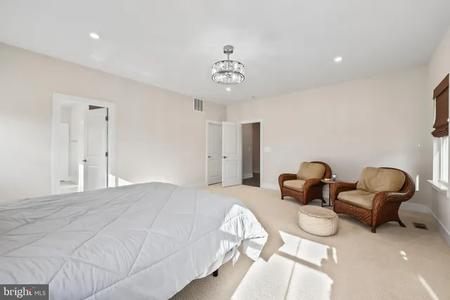 a bedroom with bed and a chair