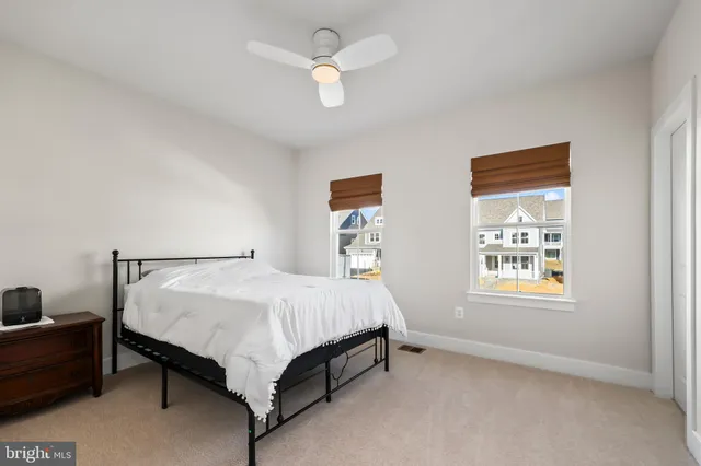 a bed sitting in a bedroom next to a window