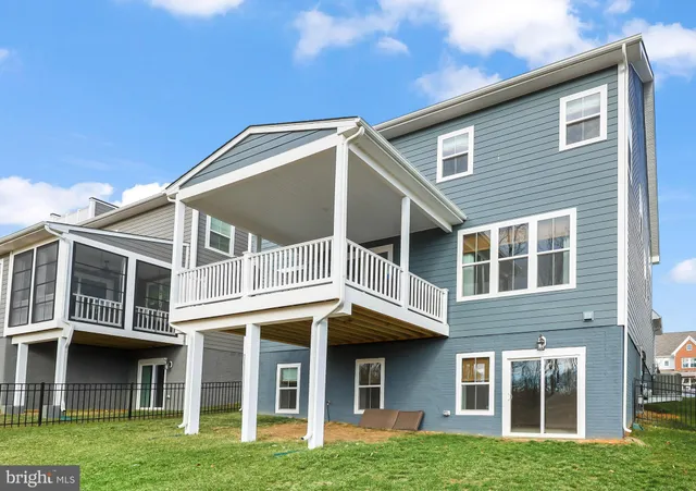 a view of a brick house with a large windows and a yard