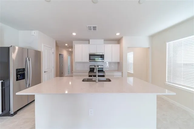 a kitchen with a refrigerator and a sink