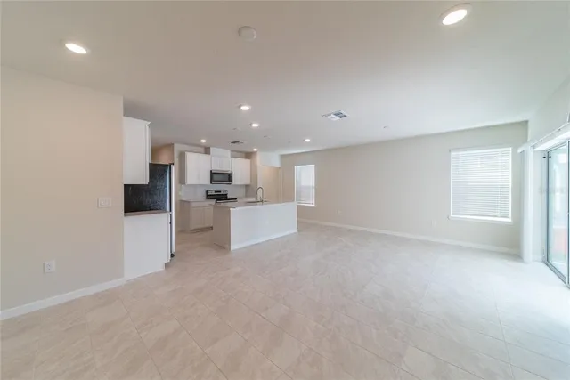 a view of an empty room and a window