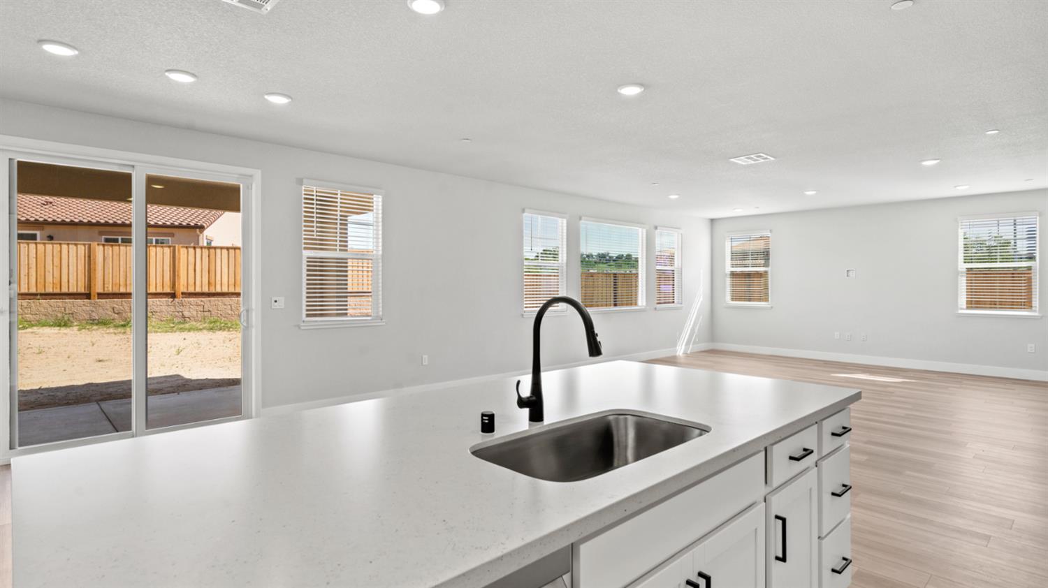 253 Rafters Court Lincoln, CA 95648 - Photo 5 of 14 a kitchen with a sink and chandelier