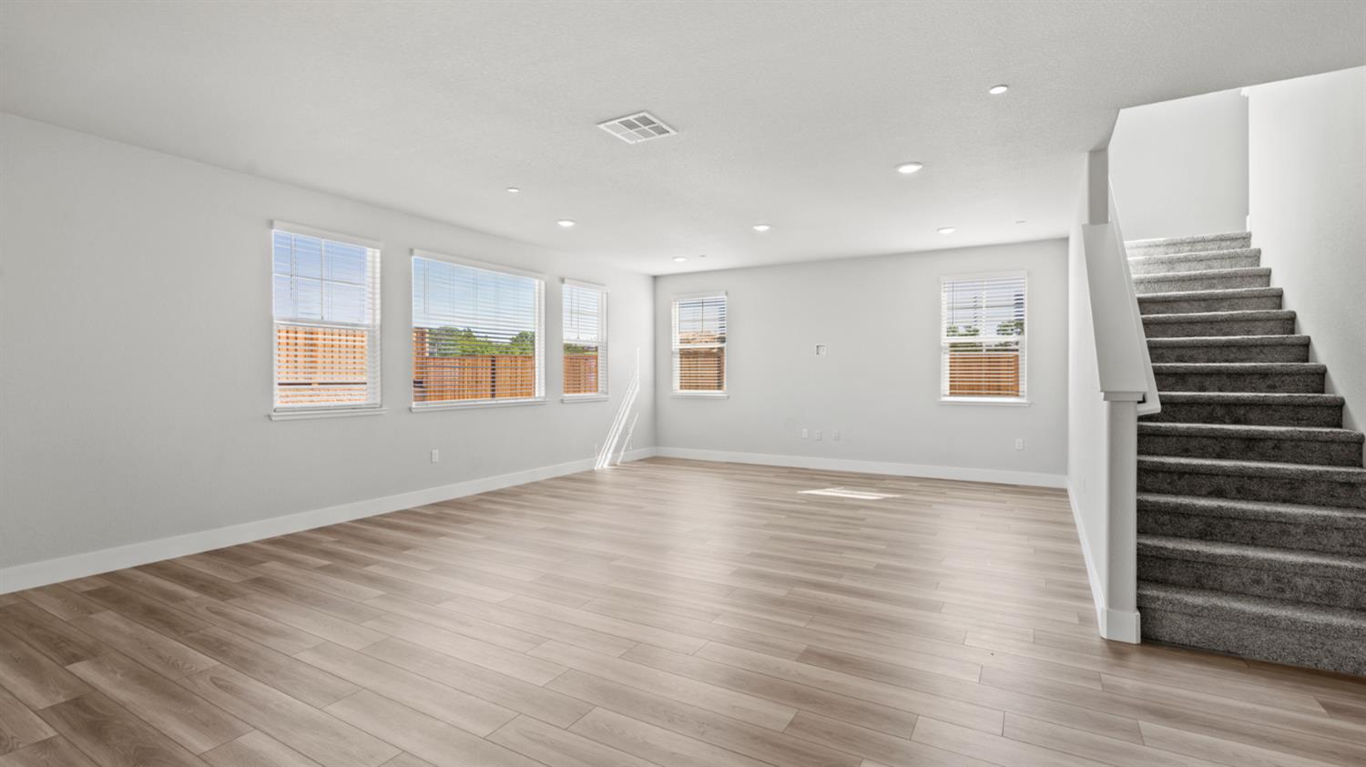 253 Rafters Court Lincoln, CA 95648 - Photo 6 of 14 a view of an empty room with wooden floor and windows