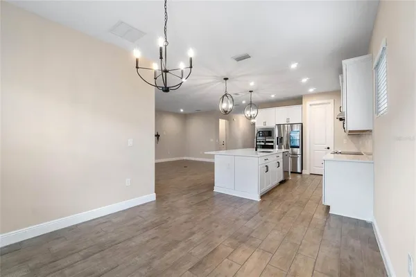 a view of kitchen with sink microwave and refrigerator
