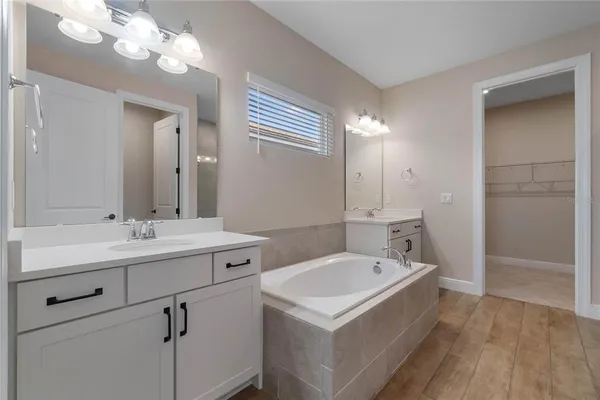 a bathroom with a sink a mirror and a shower