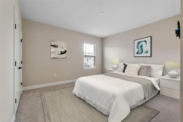a bedroom with a bed and a wall painting