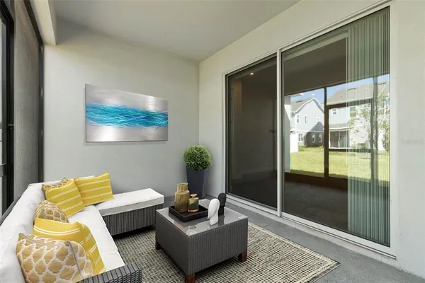 a living room with furniture and a glass door