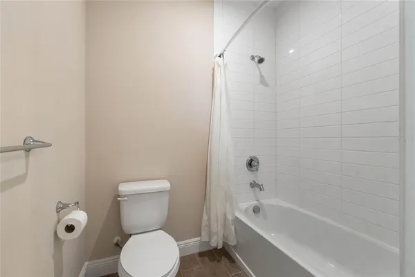 a bathroom with a toilet sink and shower