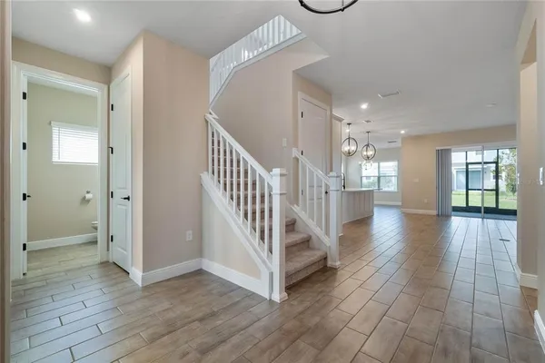 a view of a hallway with wooden floor and staircase