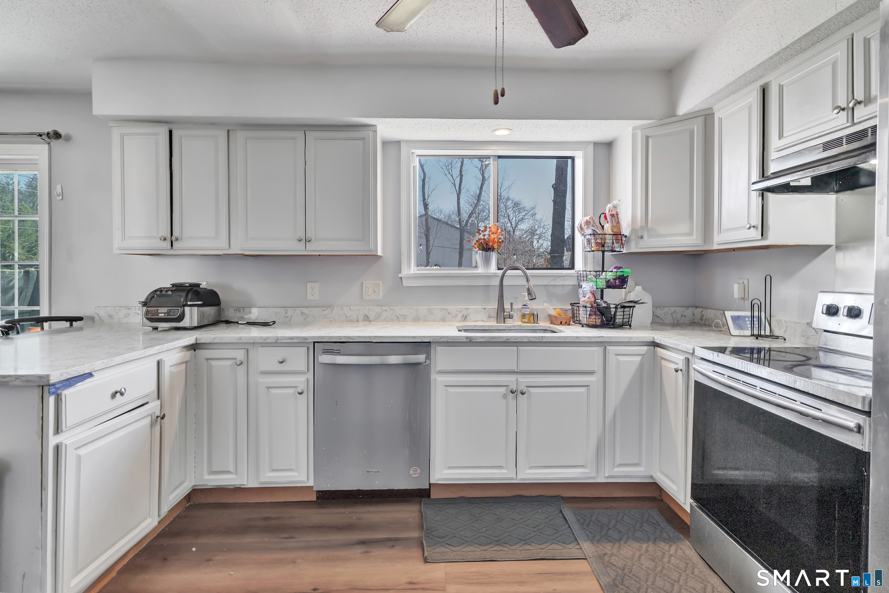 71 Cliff Street Naugatuck, CT 06770 - Photo 17 of 40 a kitchen with granite countertop white cabinets and white appliances