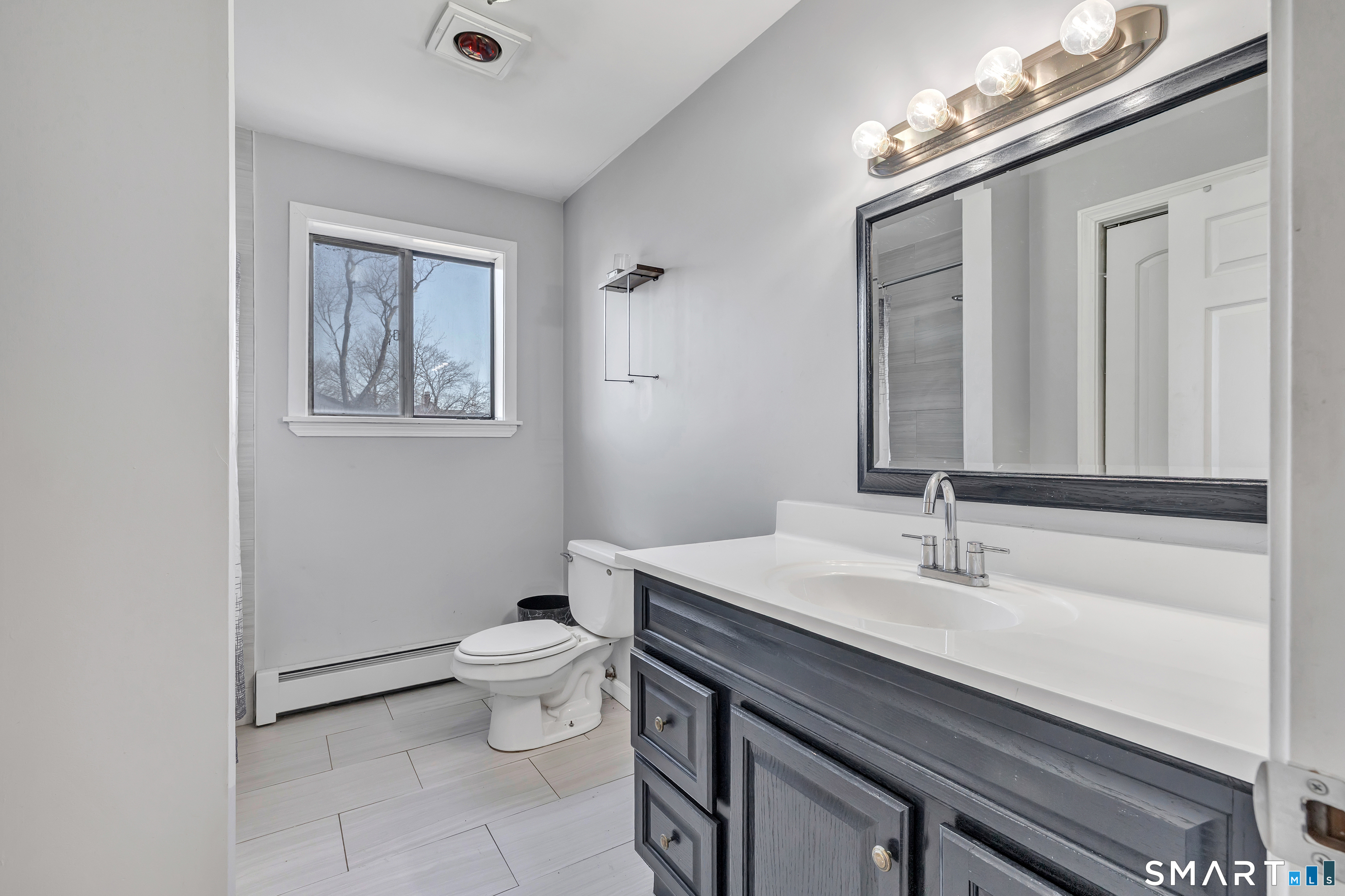 71 Cliff Street Naugatuck, CT 06770 - Photo 21 of 40 a bathroom with a sink vanity mirror and toilet