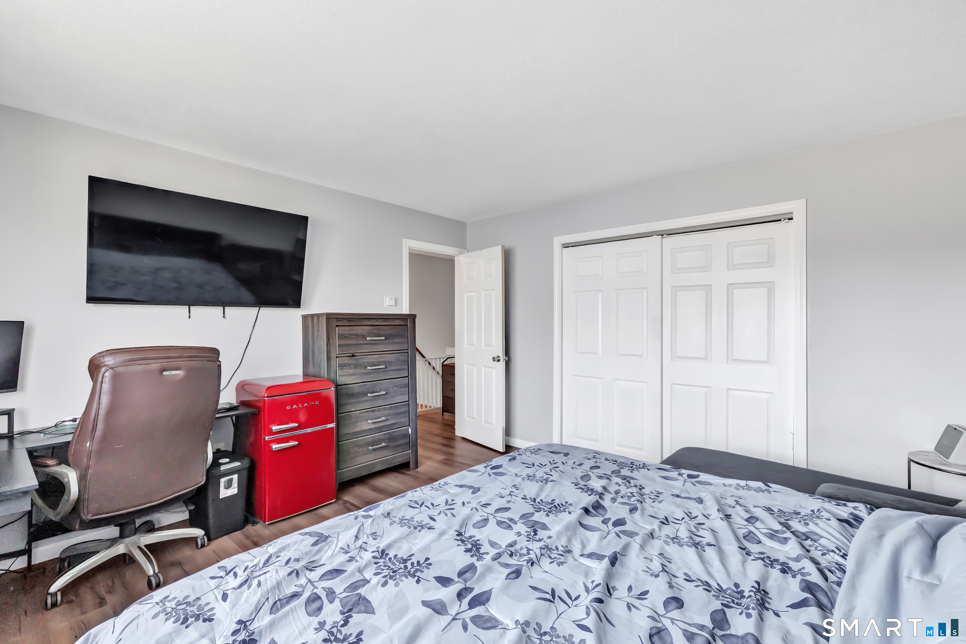 71 Cliff Street Naugatuck, CT 06770 - Photo 23 of 40 a bedroom with a bed chair and a flat screen tv