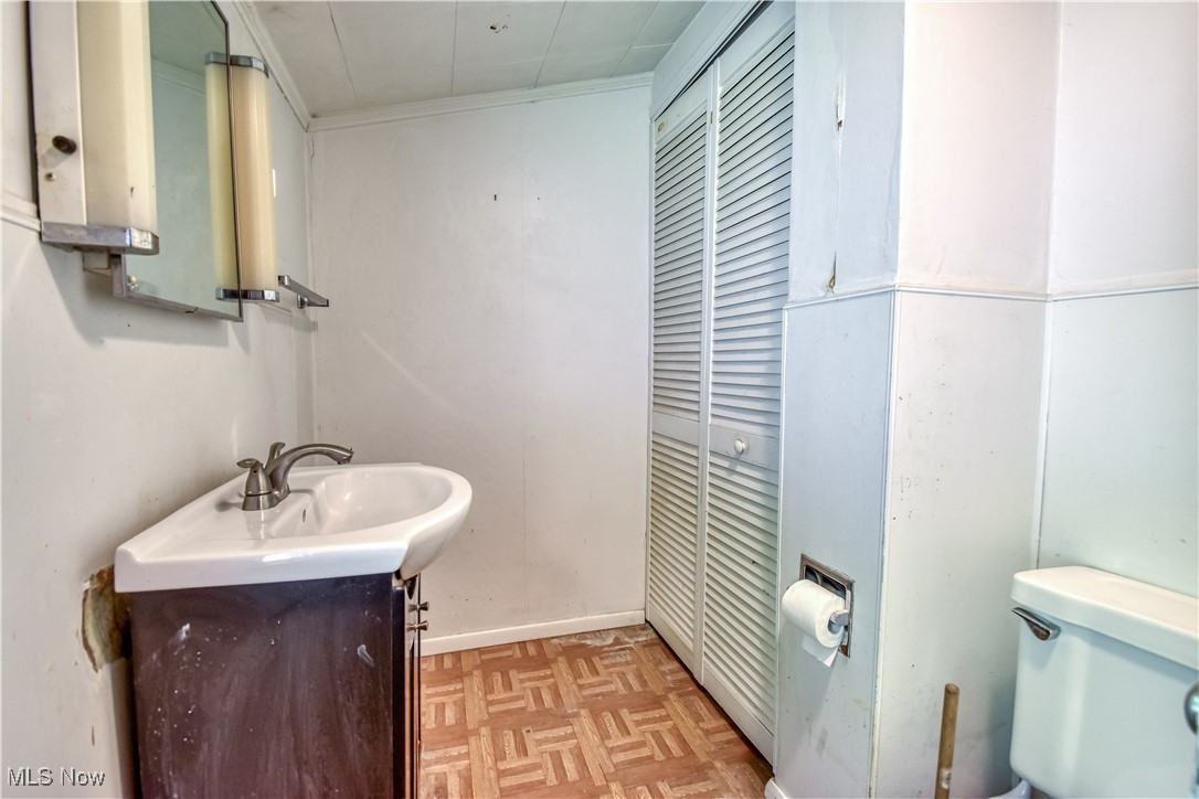 7665 Miami Road Mentor, OH 44060 - Photo 14 of 20 Half bathroom featuring vanity and crown molding
