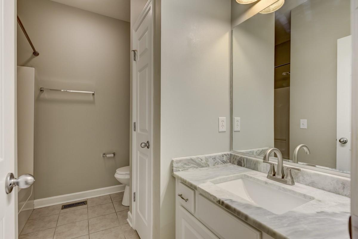 3008 Westerly Drive Franklin, TN 37067 - Photo 17 of 33 a bathroom with a granite countertop sink toilet and shower