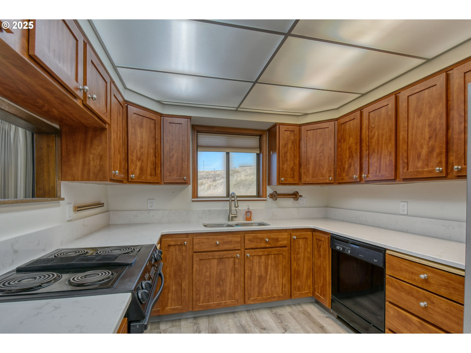 3540 Northeast King Place Pendleton, OR 97801 - Photo 18 of 48 a kitchen with a sink a stove cabinets and wooden floor