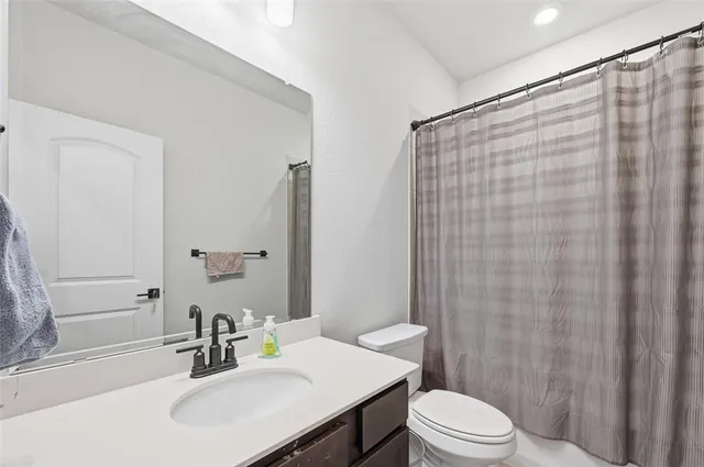 a kitchen with granite countertop stainless steel appliances and refrigerator