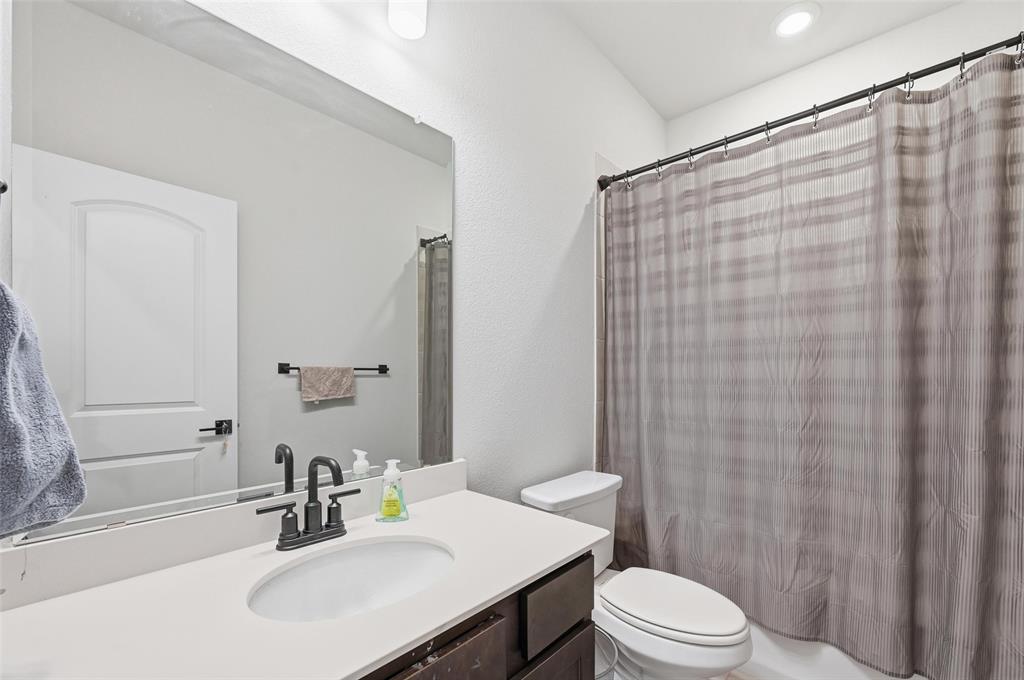 3544 Thistlewood Drive Plano, TX 75074 - Photo 7 of 24 a bathroom with a sink a toilet and shower
