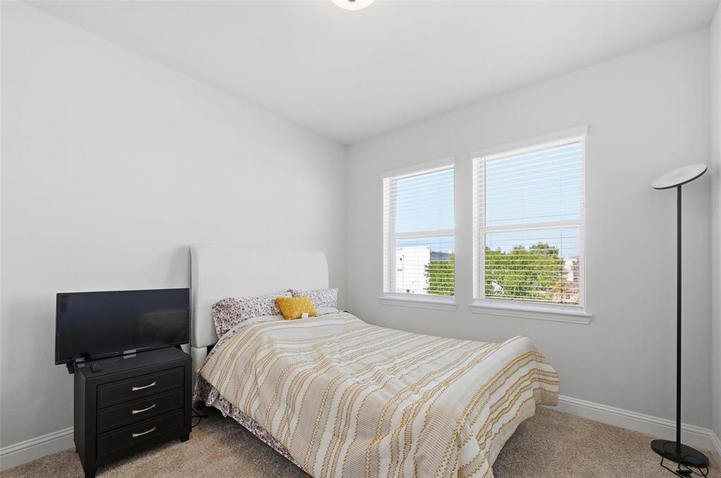 3544 Thistlewood Drive Plano, TX 75074 - Photo 8 of 24 a bedroom with a bed and flat tv screen on the dresser