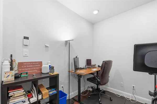 a bedroom with a bed and flat tv screen on the dresser