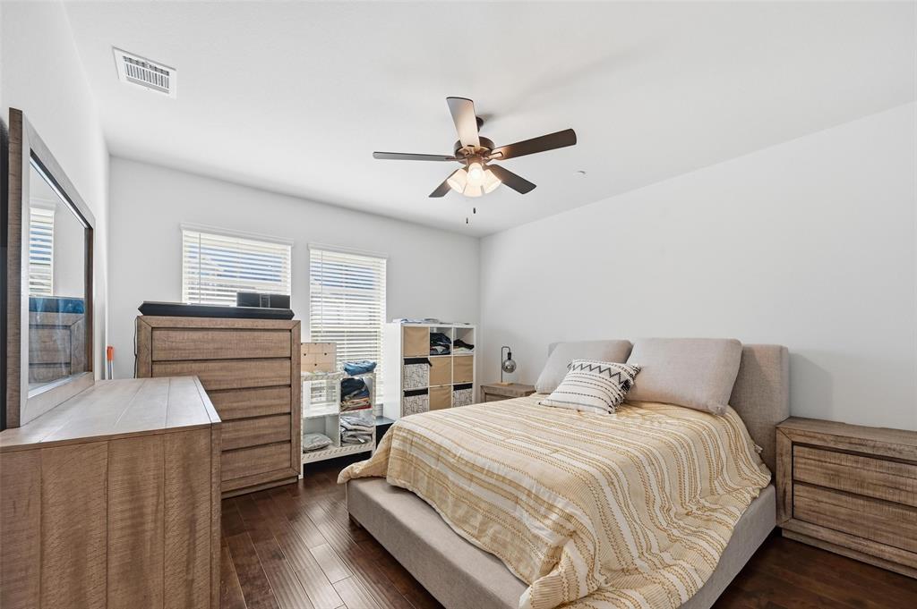 3544 Thistlewood Drive Plano, TX 75074 - Photo 11 of 24 a bedroom with a bed and wooden floor