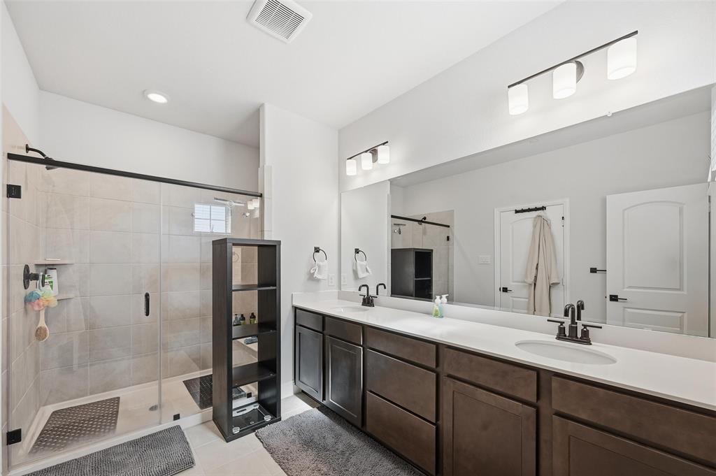 3544 Thistlewood Drive Plano, TX 75074 - Photo 13 of 24 a bathroom with a double vanity sink mirror double and shower