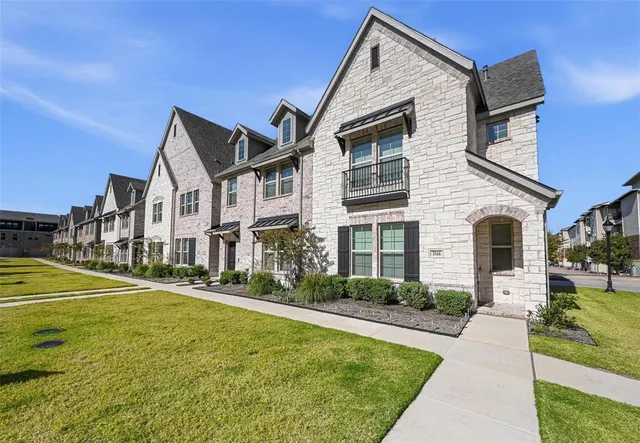 a kitchen with kitchen island stainless steel appliances a sink a stove a refrigerator and a stove