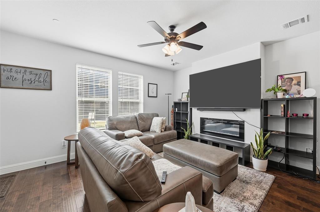 3544 Thistlewood Drive Plano, TX 75074 - Photo 2 of 24 a living room with furniture a fireplace and a flat screen tv