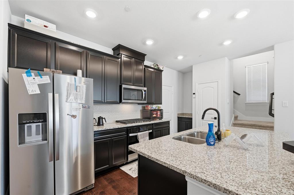 3544 Thistlewood Drive Plano, TX 75074 - Photo 5 of 24 a kitchen with granite countertop stainless steel appliances and refrigerator