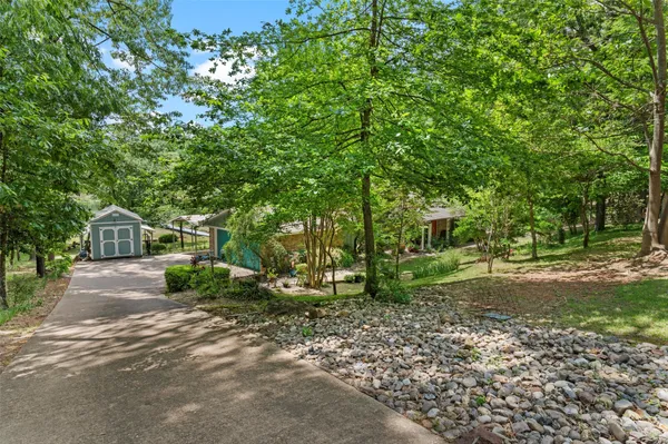 a view of a house with a yard and tree s