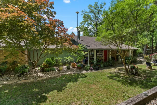 a view of backyard of house with green space