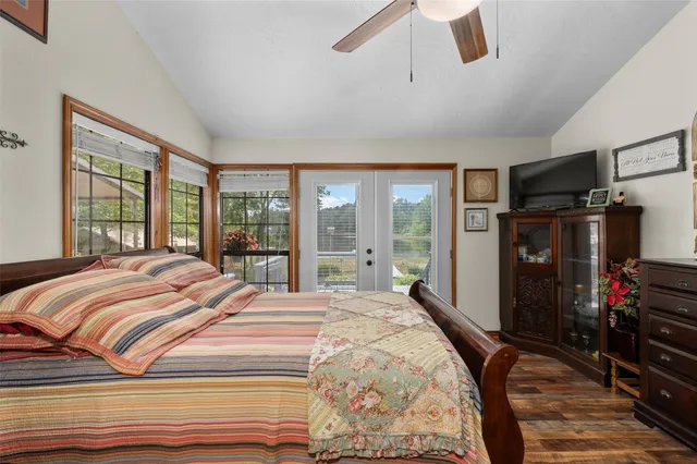 a bedroom with a bed and a large window