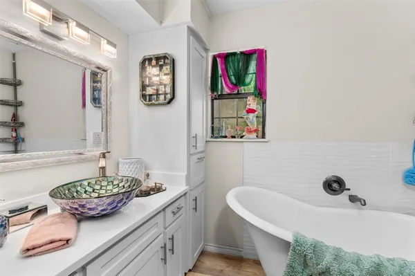 a bathroom with a tub and a sink