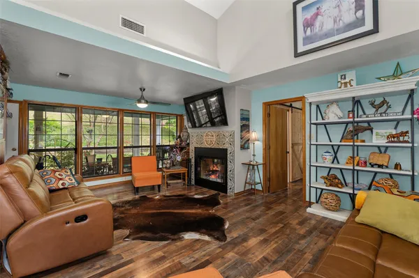 a living room with furniture large window and a fireplace